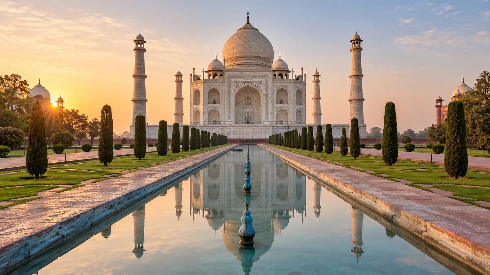 The Taj Mahal and its reflection at sunrise in Agra, India